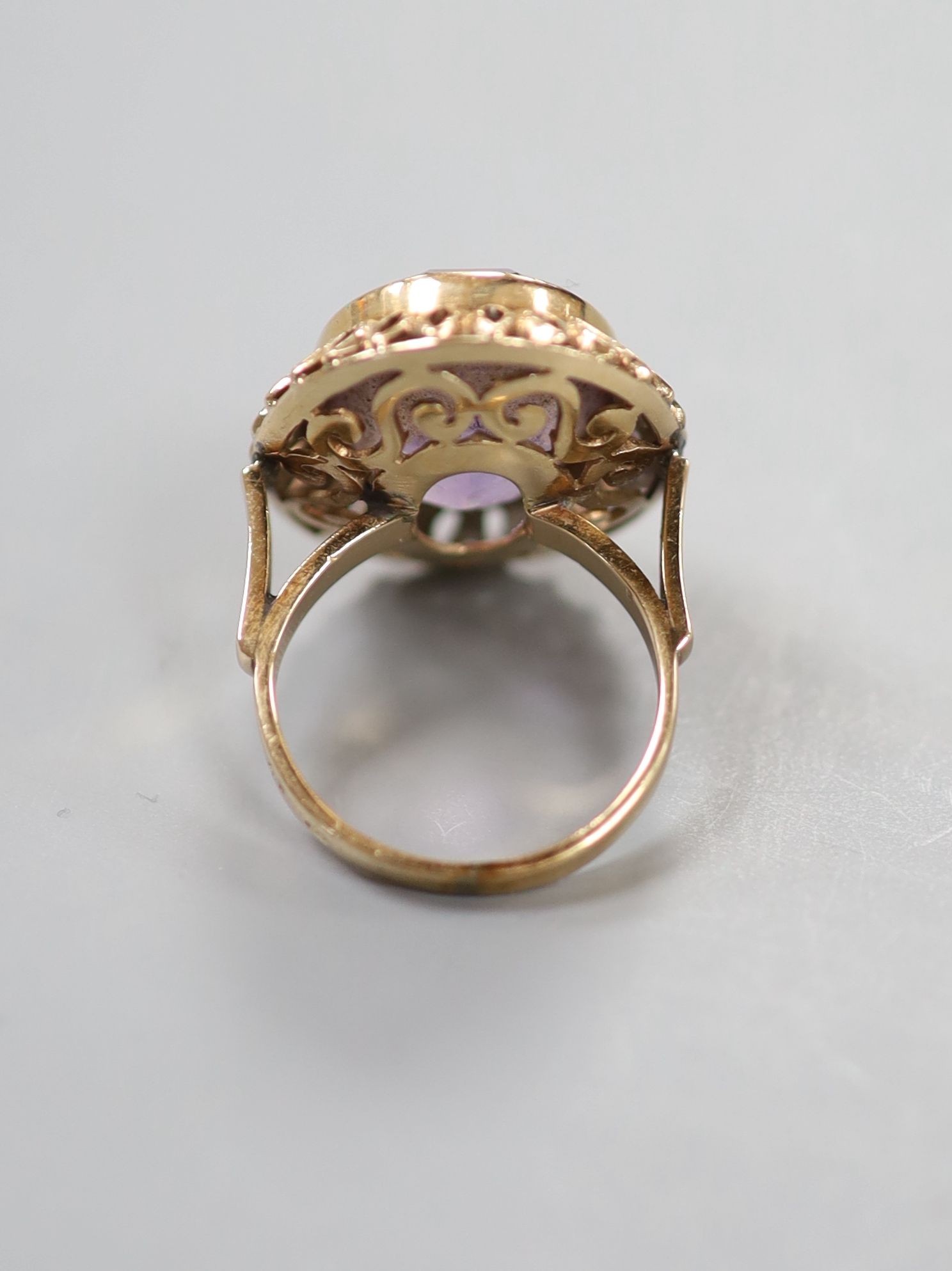 A continental 14k yellow metal and oval cut amethyst set dress ring, size M, gross weight 8.5 grams.